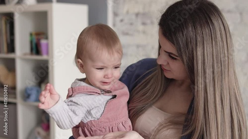 Anxious mother trying to calm down her capricious unhappy child who crying
