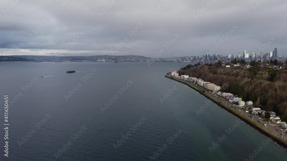 Aerial view of Alki Beach in West Seattle surrounded by the water of the Puget Sound Aerial view of Alki Beach in West Seattle surrounded by the water of the Puget Sound