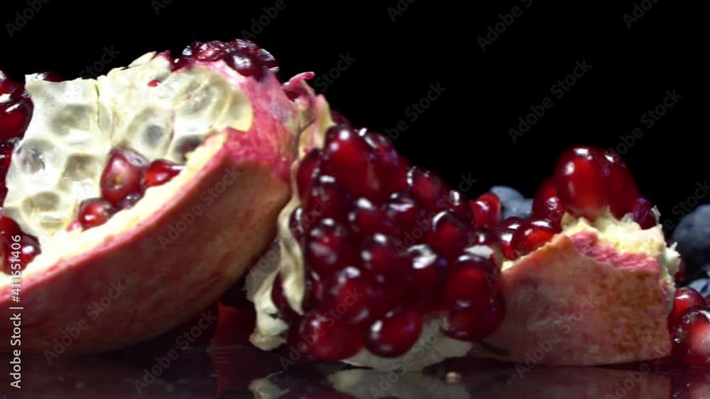 Pomegranate seeds and blueberries close up on a rotating surface Pomegranate seeds and blueberries close up on a rotating surface