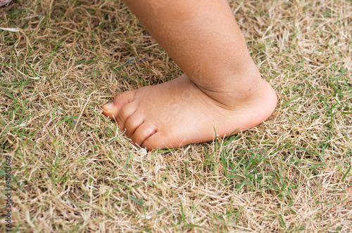 baby foot on the grass with copy space
