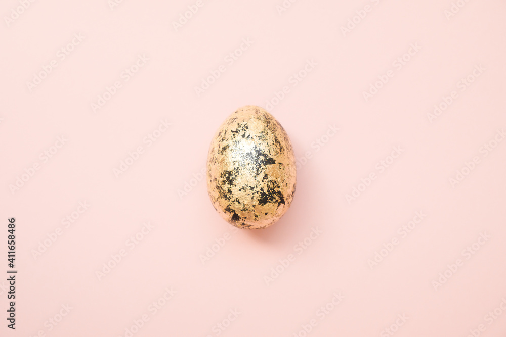 Easter decorated with golden potal egg on pastel pink background. Minimal easter concept. Happy Easter card with copy space for text.