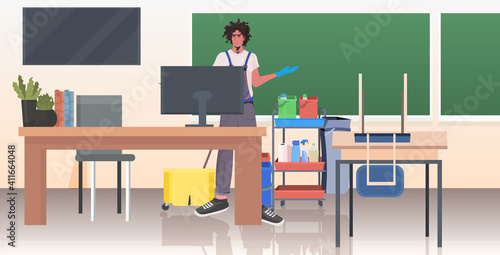 professional cleaner male janitor cleaning and disinfecting floor to prevent coronavirus pandemic modern school classroom interior horizontal full length vector illustration