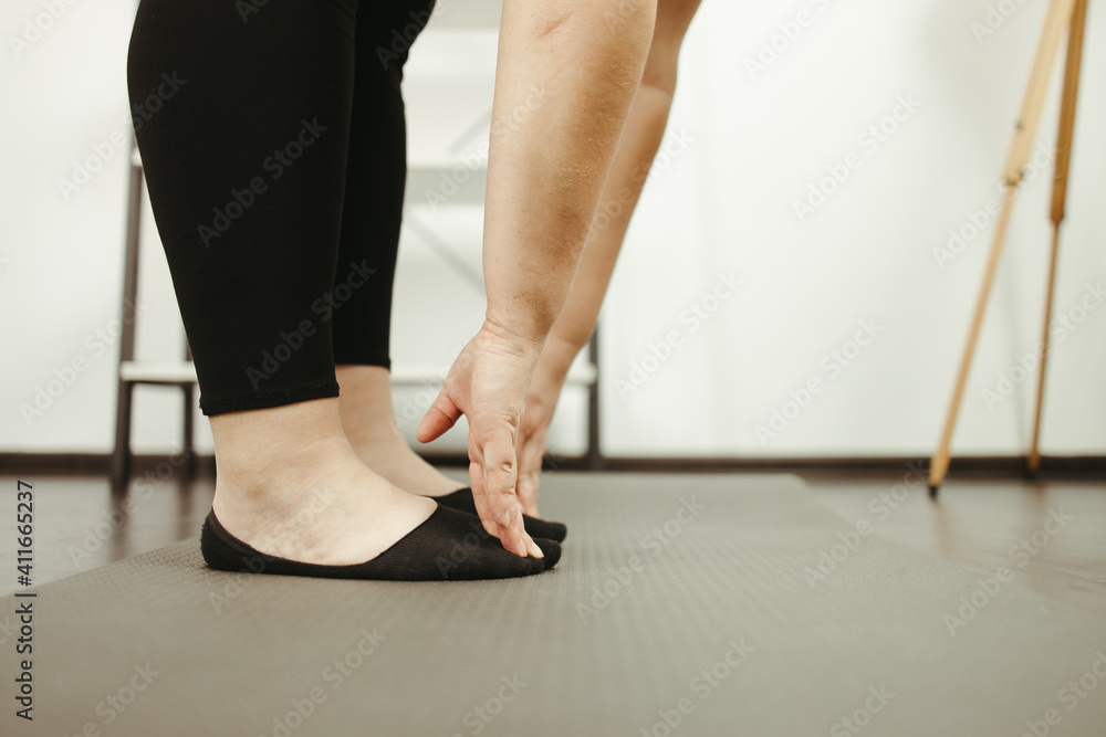 overweight woman doing stretching exercise at home overweight woman doing stretching exercise at home