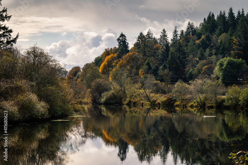 Serene autumnal Coquille river in Oregon during cloudy day