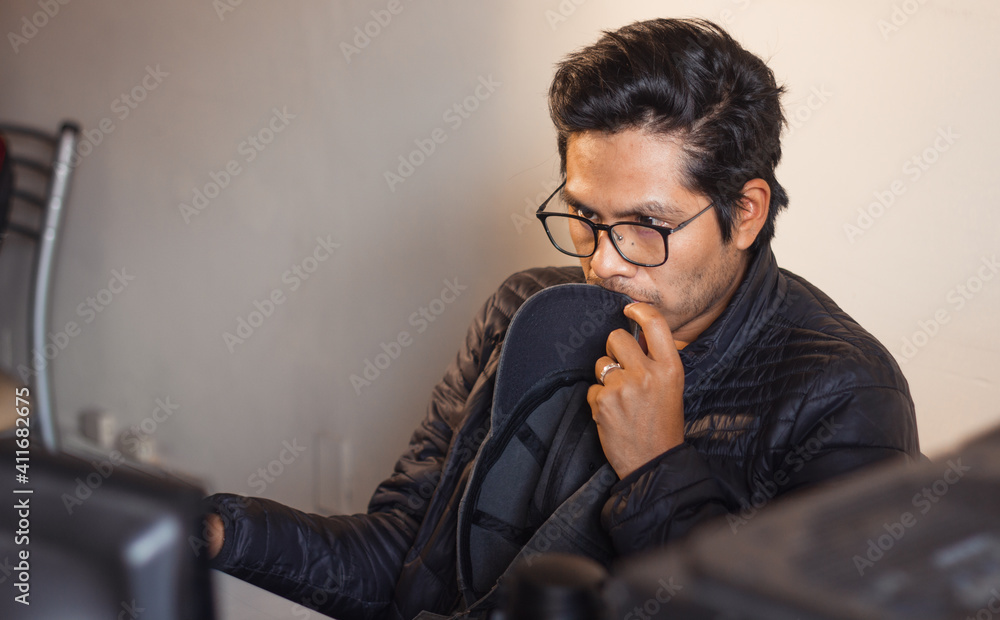 young man working with computer from his quarantined office young man working with computer from his quarantined office