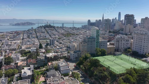 San Francisco, CA, USA. Tennis circuit on the steep hill in business block. Bay Area with dense development and Golden Gate Bridge in the background. High quality 4k footage