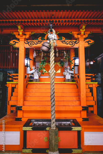 Shinto altar with rope and bell and light at Yasaka shrine in night, Kyoto, Japan photo