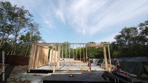 Wallpaper Mural Timelapse of two builders moving the front wall on the place. Frame house building site Torontodigital.ca
