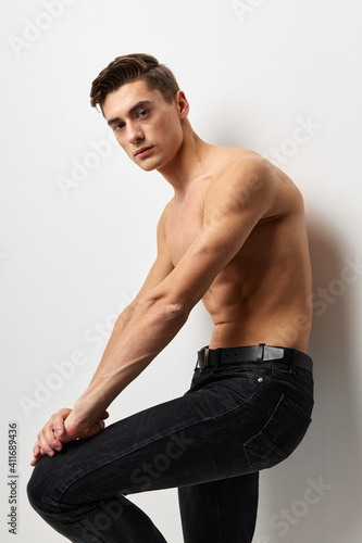 Handsome male nude torso black pants portrait studio isolated background