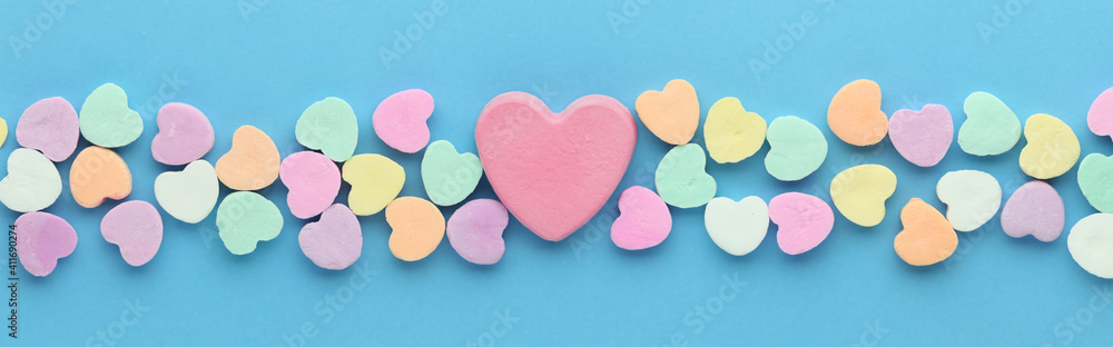 Candy hearts for Valentines day with a large blank pink heart in the center.