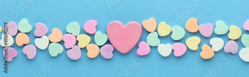 Candy hearts for Valentines day with a large blank pink heart in the center.