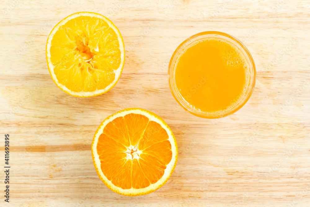 Fresh orange juice on wooden cutting board Fresh orange juice on wooden cutting board