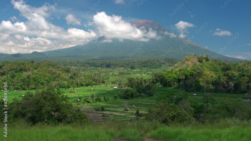Nature landscape beautiful rice terrace Bali on background active volcano Gunung Agung or Mount Agung hidden in clouds. Beautiful Bali destination in 4K Nature landscape beautiful rice terrace Bali on background active volcano Gunung Agung or Mount Agung hidden in clouds. Beautiful Bali destination in 4K