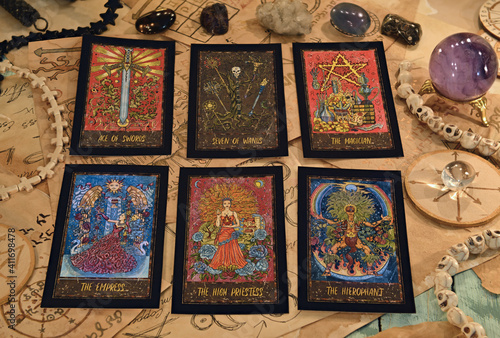 Tarot cards with magic objects and crystals on witch table. © samiramay