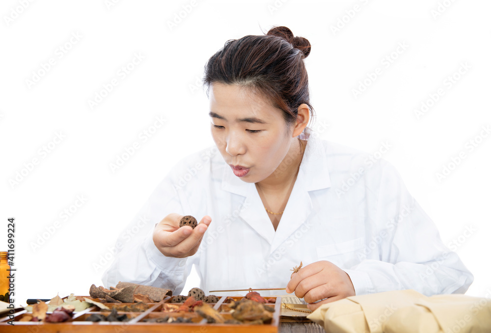 Female pharmacist checking traditional Chinese Medicine Female pharmacist checking traditional Chinese Medicine