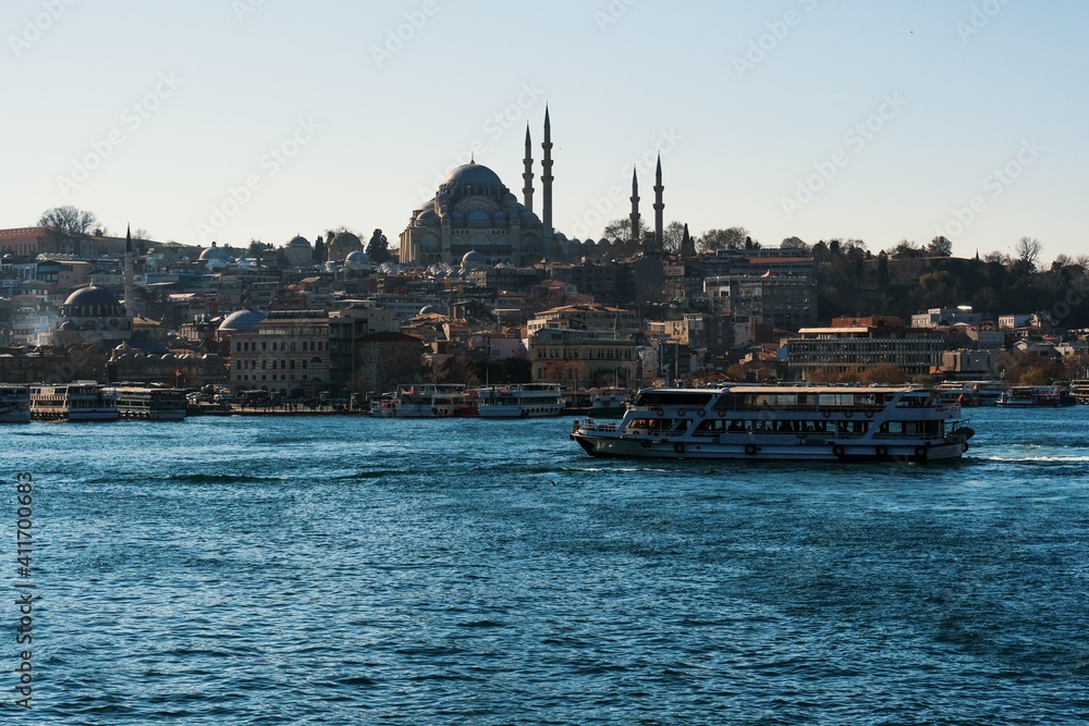 Great Mosque in Istanbul. View from a high bridge, where local fishermen fish with fishing rods. The passenger liner is sailing on the Bosphorus Gulf. Great Mosque in Istanbul. View from a high bridge, where local fishermen fish with fishing rods. The passenger liner is sailing on the Bosphorus Gulf.