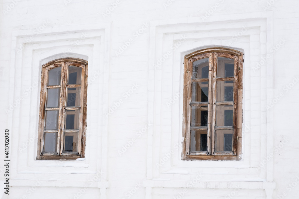 Two carved windows of old wooden house in historical town