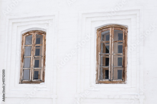 Two carved windows of old wooden house in historical town