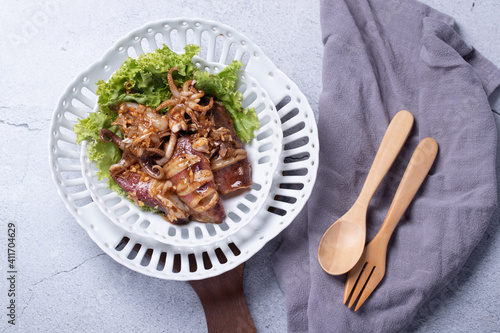 Fried squid with garlic in a semic dish photo