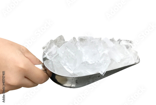 Close up female hand holding stainless ice scoop with ice cubes isolated on white background.