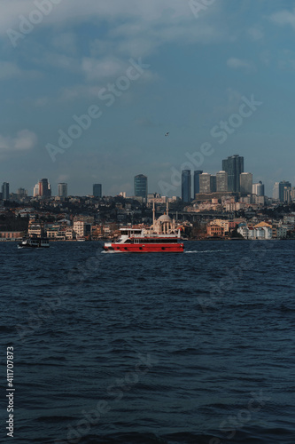 A passenger red motor ship sails on the Bosphorus Gulf in Istanbul.