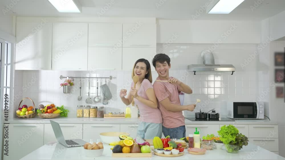 Couple young asian prepares healthy breakfast with fruits happiness and smile Couple young asian prepares healthy breakfast with fruits happiness and smile