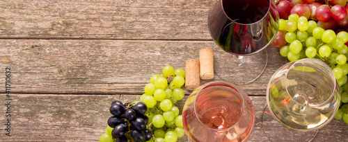 Variety of wine and snack set. Different types of grapes. Fresh ingredients on wooden background.
