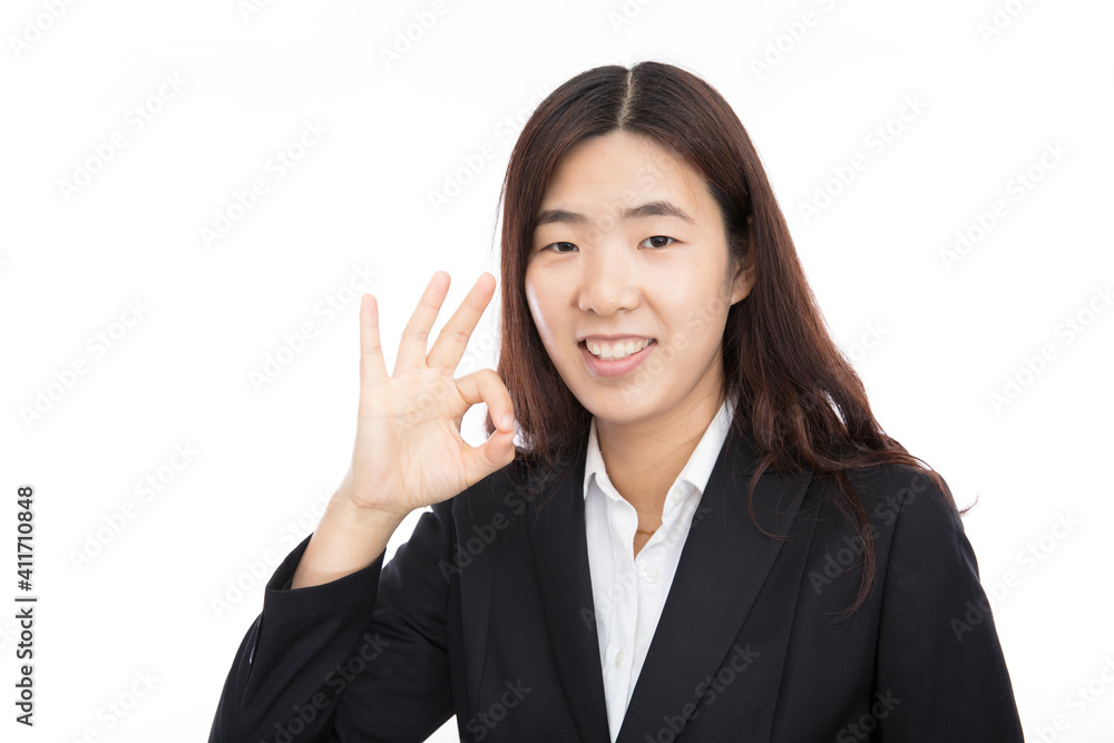 Young professional women make OK gestures in front of white background Young professional women make OK gestures in front of white background