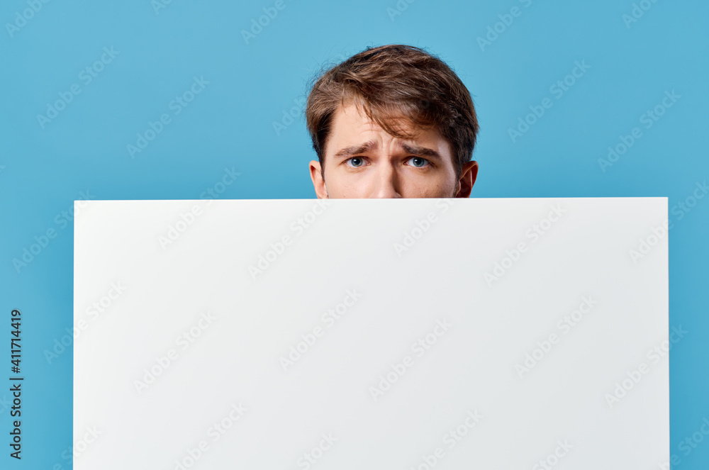 peeping from behind a billboard advertisement copy space isolated background close-up peeping from behind a billboard advertisement copy space isolated background close-up