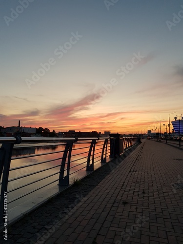 Embankment under an orange evening sky © kos1976