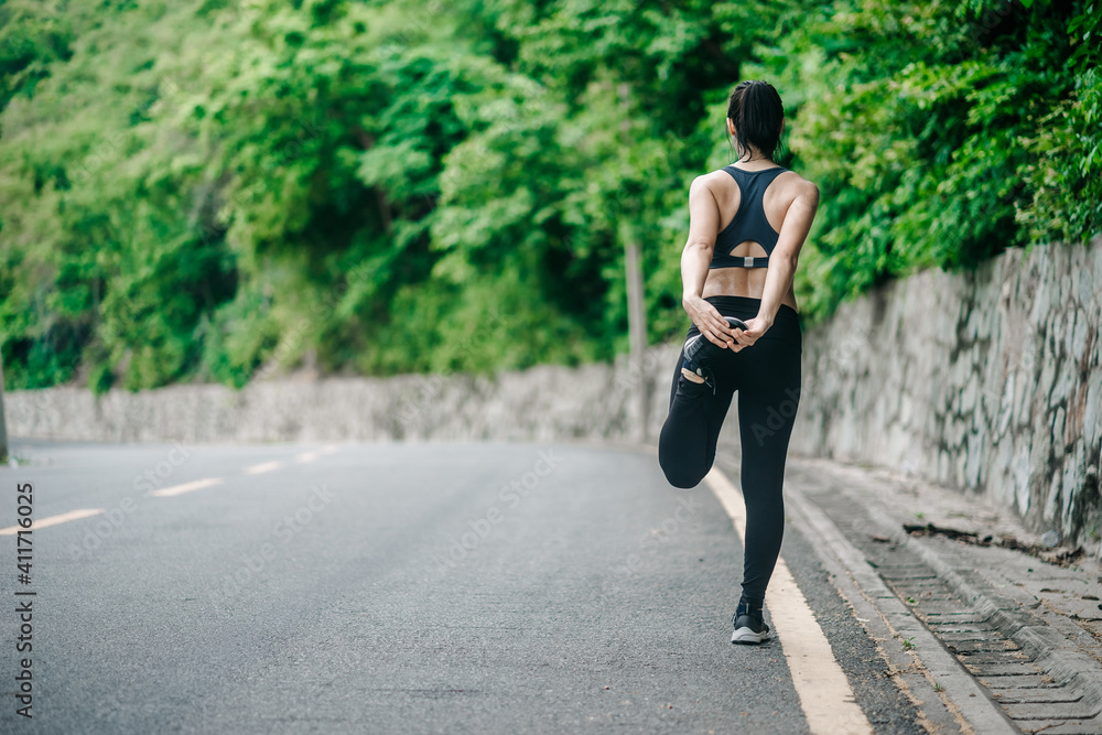 Foto de Asian fitness runner body closeup doing warmup routine on