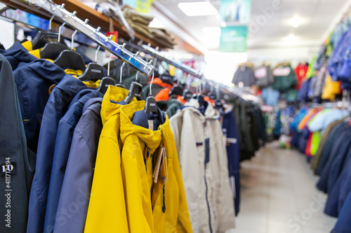 Children winter clothing on hangers in clothing shop interior