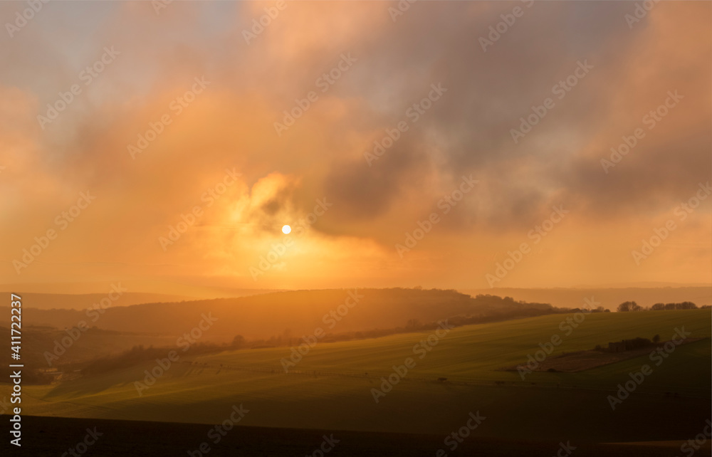 Sun setting over the south downs near Jevington East Sussex south east England.