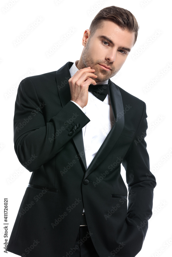 portrait of elegant young businessman holding hand in pocket
