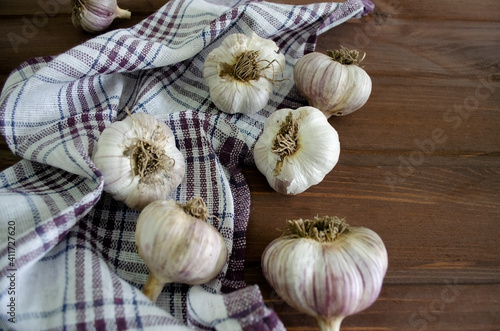 garlic on a wooden background and a napkin close up
