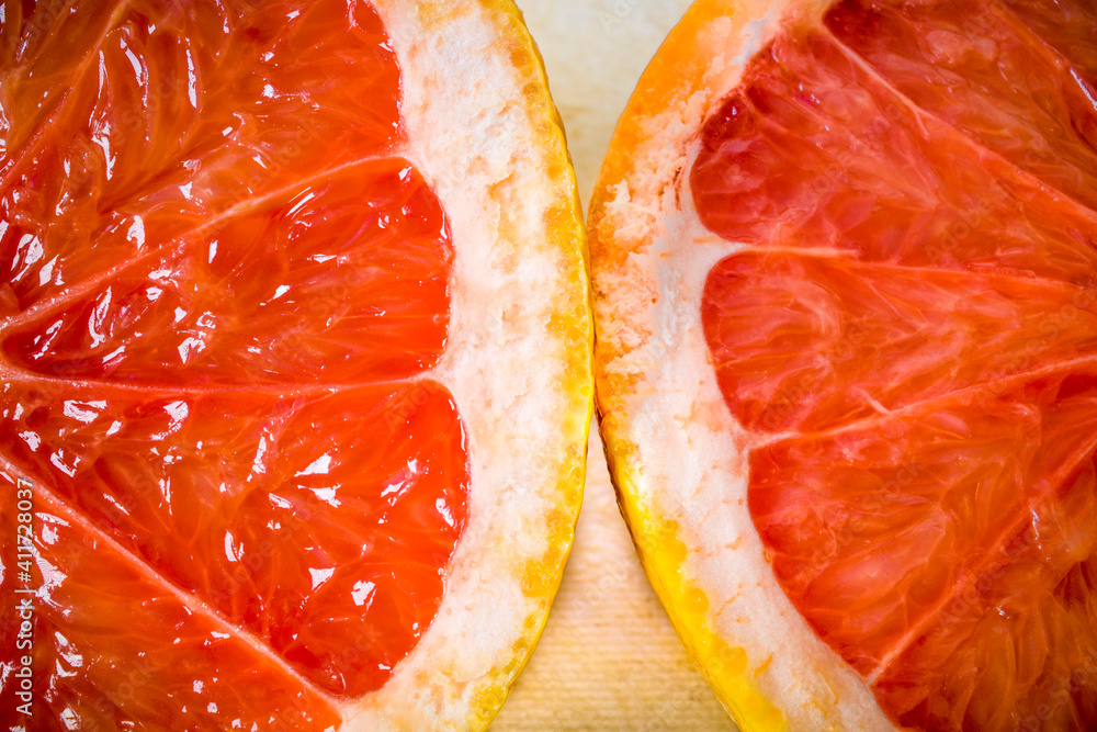 A half of a grapefruit on a cutting board. A half of a grapefruit on a cutting board.