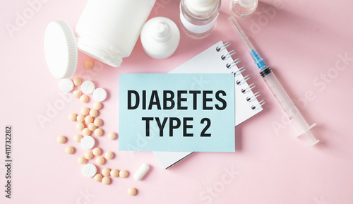 Diabetes type 2 - Diagnosis written on a white piece of paper. Treatment and prevention of disease. Syringe and vaccine with drugs. Medical and Healthcare concept. Selective focus photo
