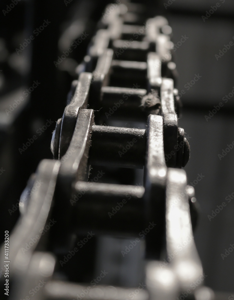 Part of an old control chain of a vintage machinery. Close-up picture of some chain links. Part of an old control chain of a vintage machinery. Close-up picture of some chain links.