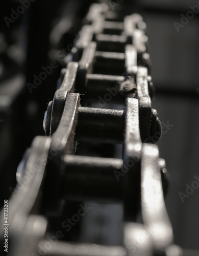 Part of an old control chain of a vintage machinery. Close-up picture of some chain links.
