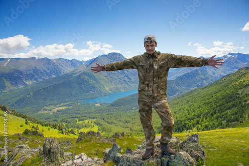 Portrait of a teenage boy on a background of mountains.