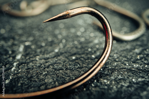 Slika na platnu Macro photo of fishing hook on grey background