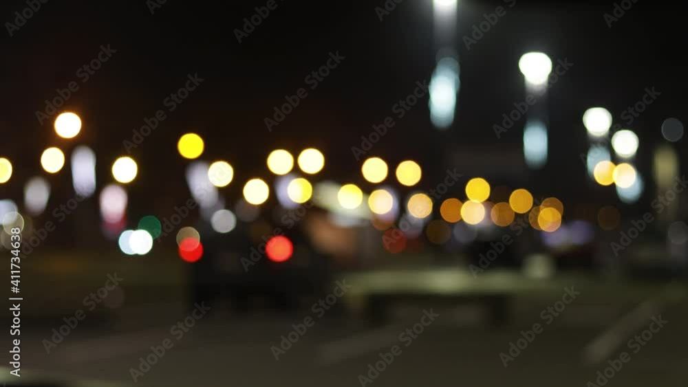 The round colorful bokeh of car and traffic lights of night city. Beautiful glittering bokeh in dark blurry background at night. Blurry background for intro. The round colorful bokeh of car and traffic lights of night city. Beautiful glittering bokeh in dark blurry background at night. Blurry background for intro.