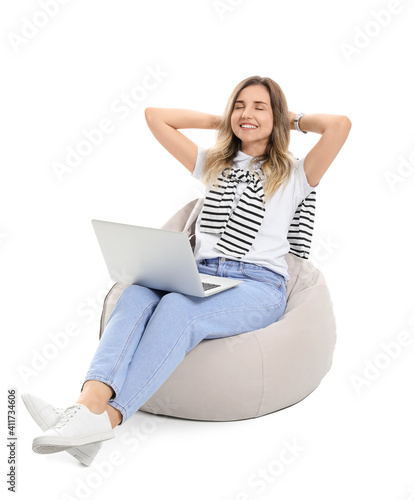 Young woman with laptop on ...