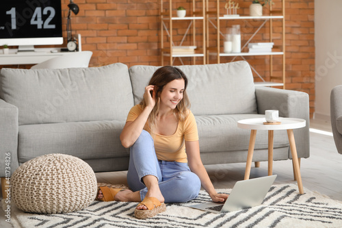 Young woman with laptop at ...