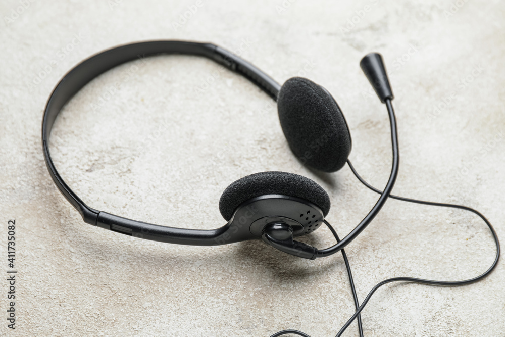 Headphones with microphone on grunge background Headphones with microphone on grunge background