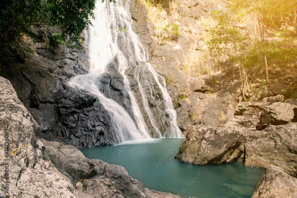 Naklejka premium Beautiful waterfall nature scenery of deep forest in summer day