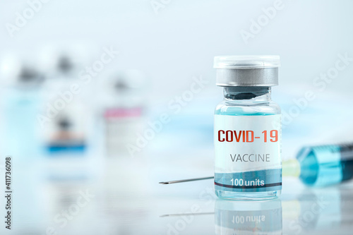 Blue vaccine jar bottle and syringe injection for treatment from corona virus infection and build immunity to viruses Covid-19 , Healthcare And Medical concept.