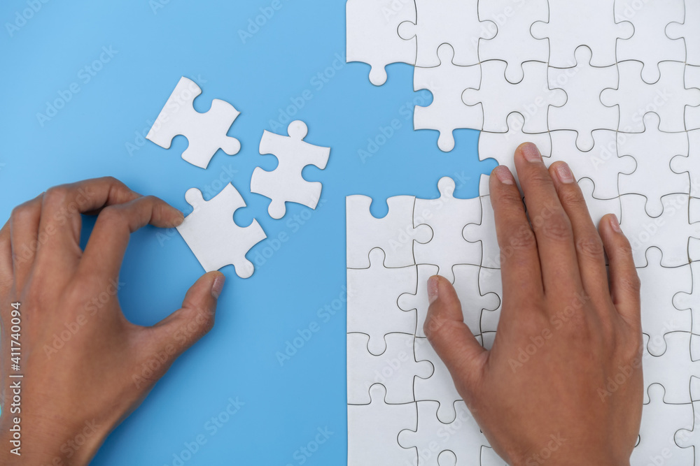 Pieces of jigsaw puzzle in man's hands, Business solutions, success and strategy concept. Pieces of jigsaw puzzle in man's hands, Business solutions, success and strategy concept.