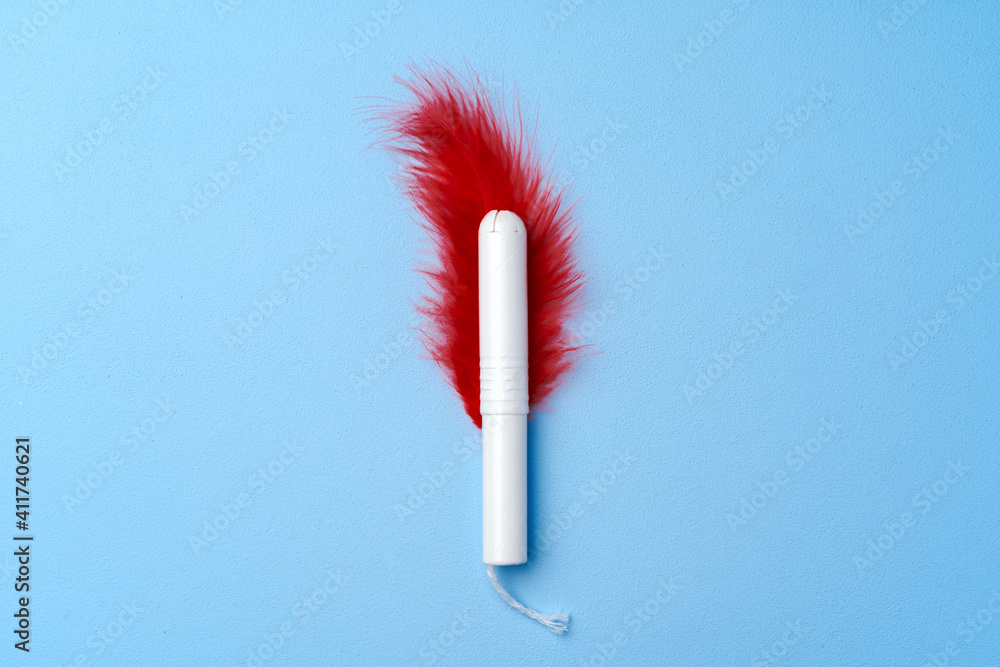 Hygienic female tampon on a blue background Hygienic female tampon on a blue background