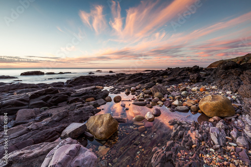 A pink sunset reflecting in rock pools at Hallett Cove South Australia